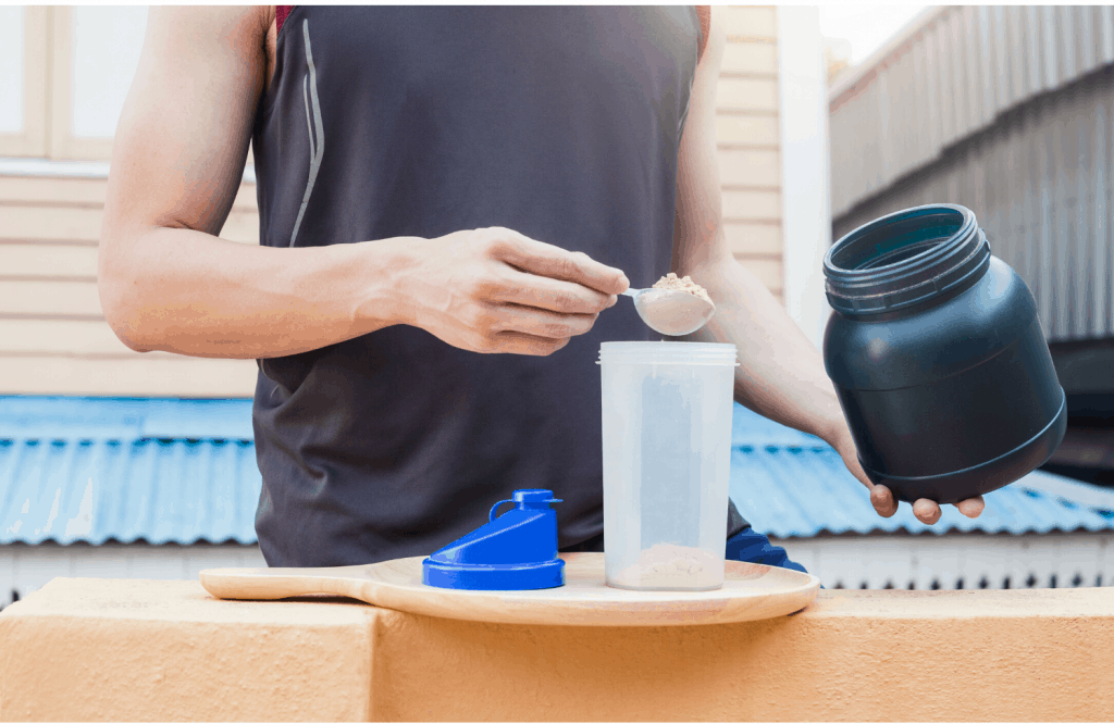 man scooping protein powder into a bottle